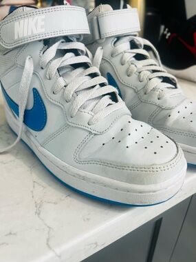 Nike White High-Top Sneakers with Blue Swoosh and Sole